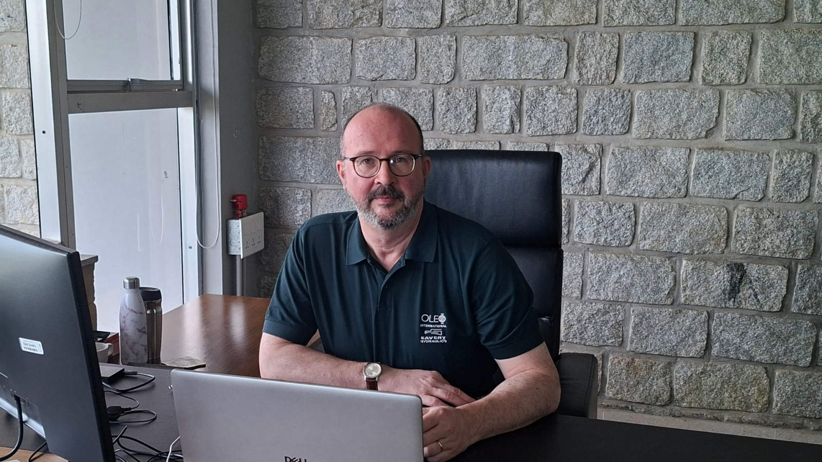 Ian Nolan - Group Operationd Director sitting at his desk.