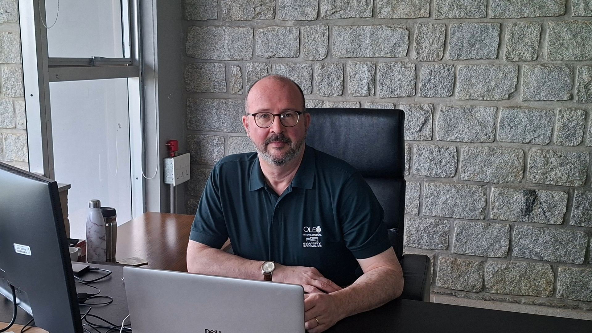 Ian Nolan - Group Operationd Director sitting at his desk.