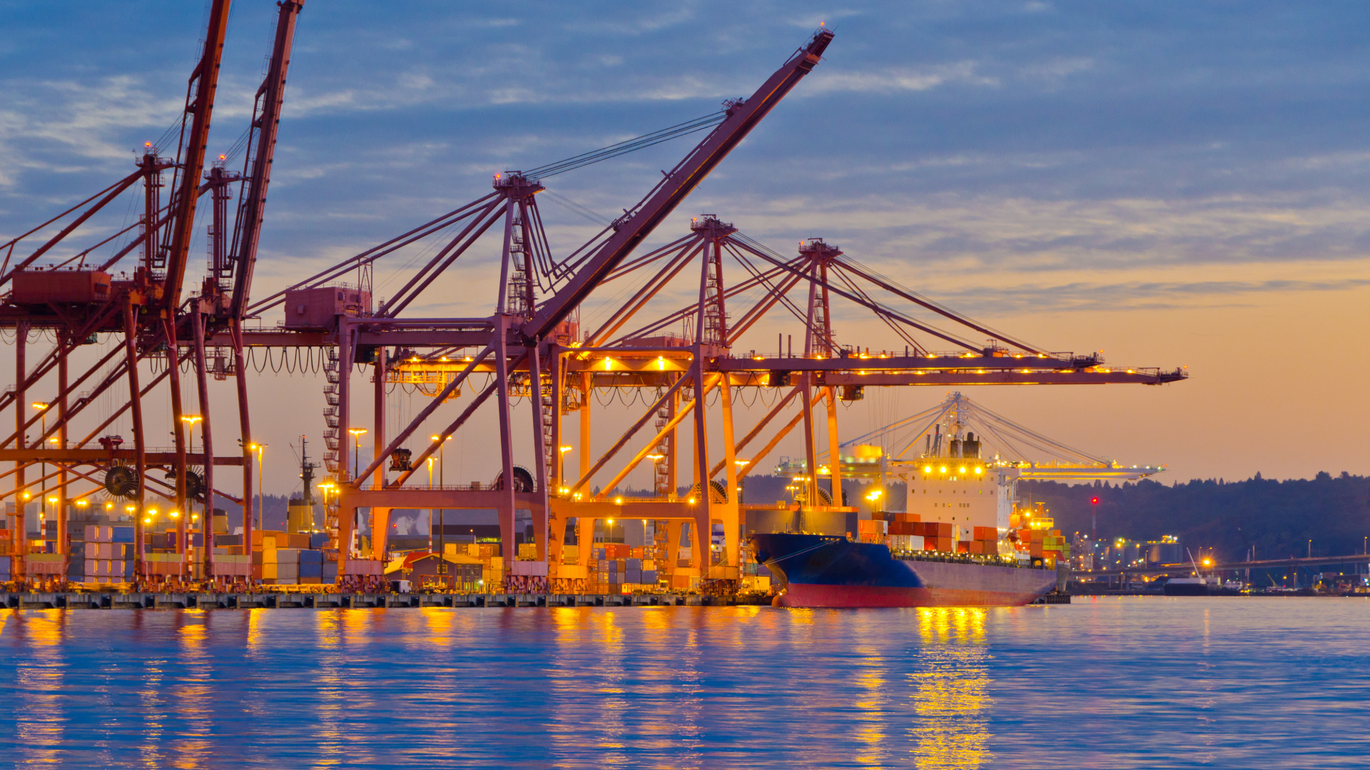 A port with yellow cranes at sunset